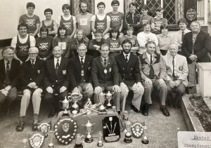 Group of rowers with trophies
